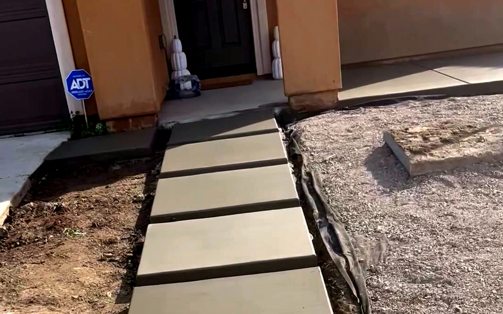 Finished floating concrete step walkway leading to the same front door