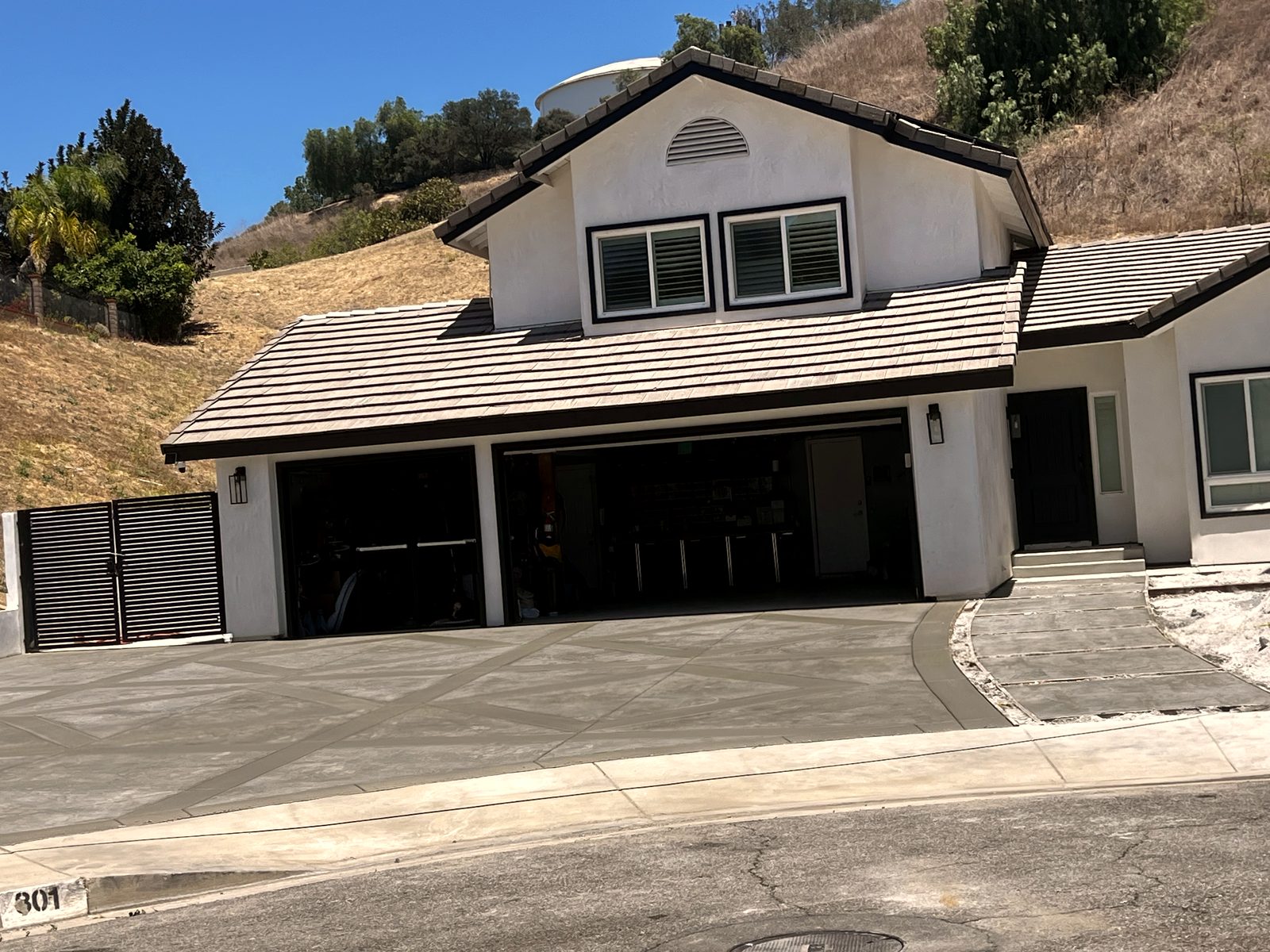 Finished diamond-scored concrete driveway at a hillside home
