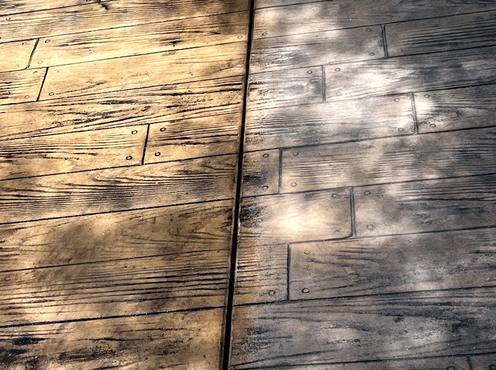 Close-up of two-tone wood-plank stamped concrete with realistic grain